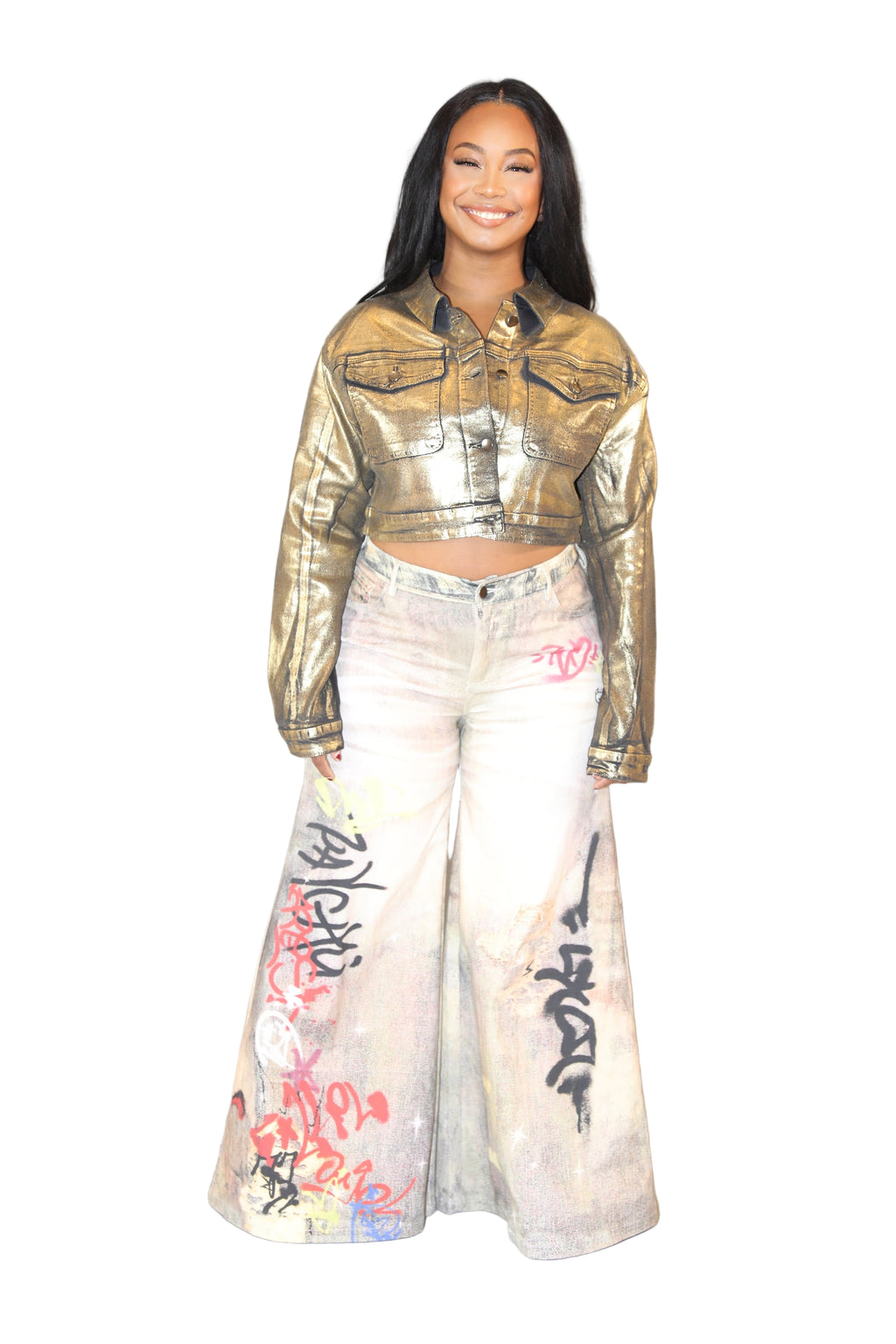 Person wearing a gold jacket and white pants with graffiti design on a plain background
