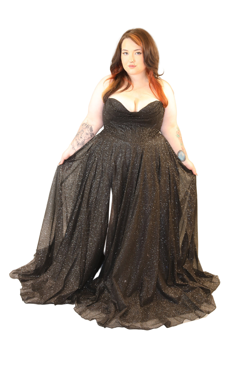 Woman wearing a black sparkly evening gown on a white background