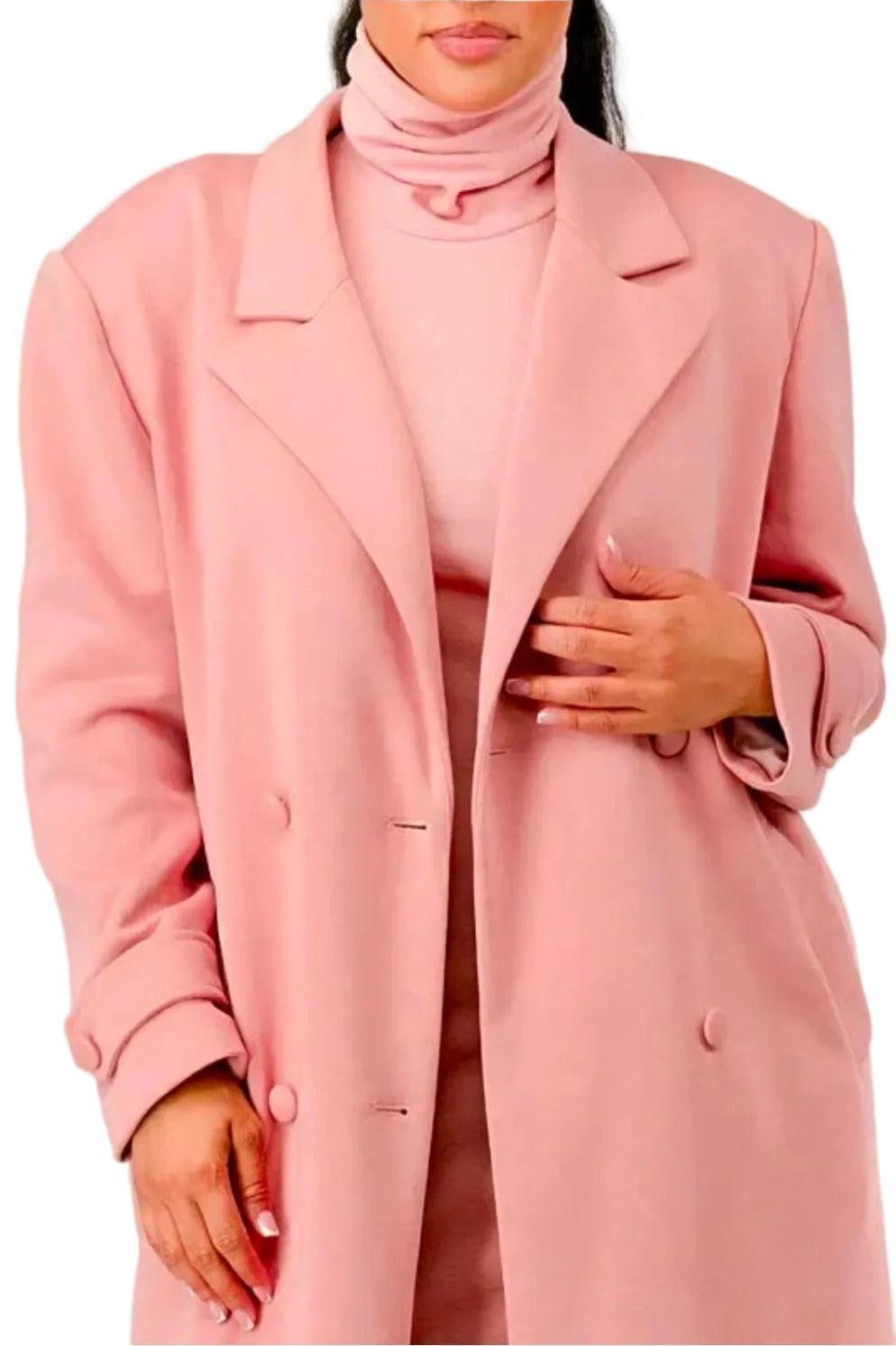 Person wearing a pink coat and turtleneck against a white background