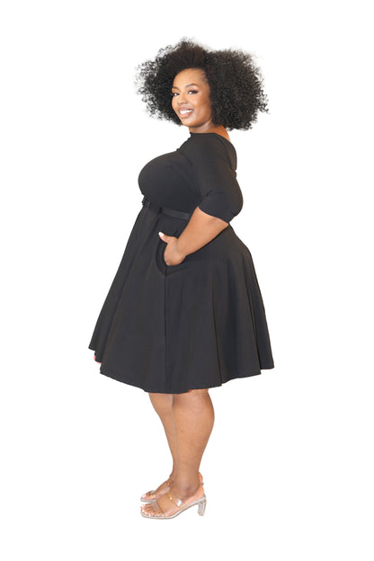 Woman wearing a black dress against a white background