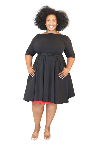 Plus Size woman wearing a Black swing dress with red under tutu