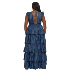 Woman wearing a blue tiered dress on a white background (back)