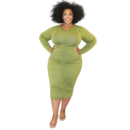 Woman wearing a green dress against a white background (front)