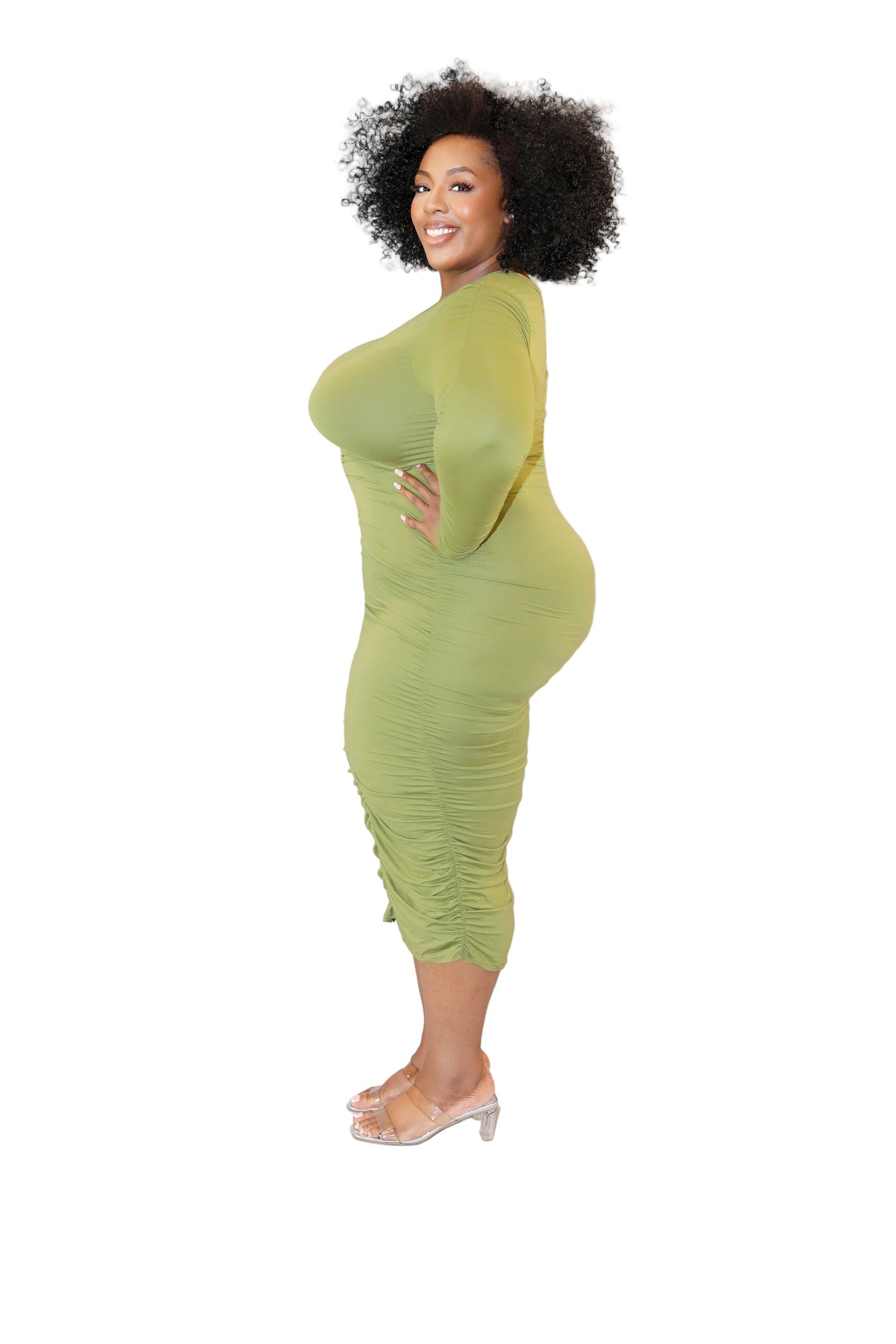Woman wearing a green dress against a white background (left side)