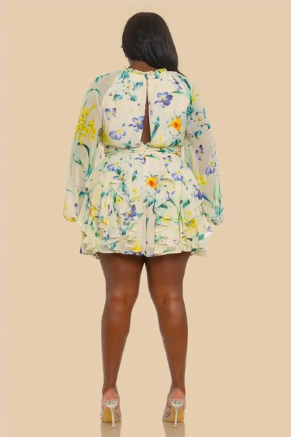 Woman wearing a floral romper on a beige background (back)