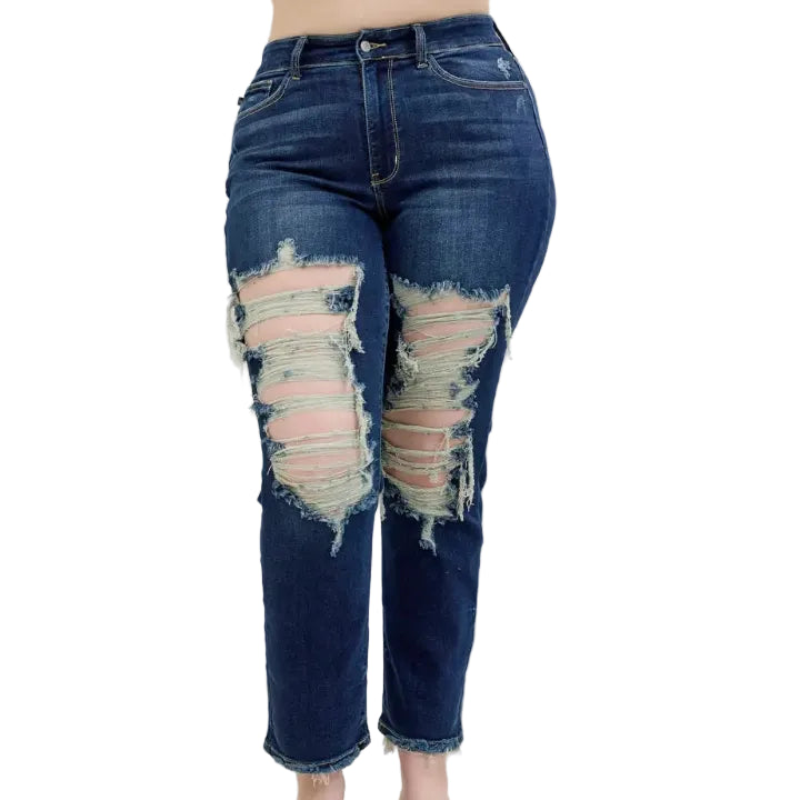 Woman wearing distressed dark wash blue jeans on a white background (front)