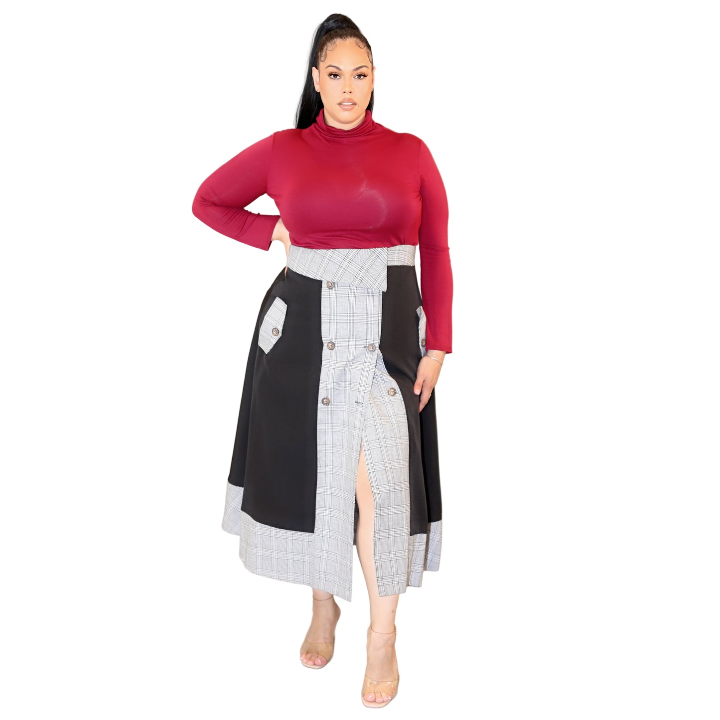 Woman wearing a red long-sleeved top and a black and monochrome plaid skirt on a white background