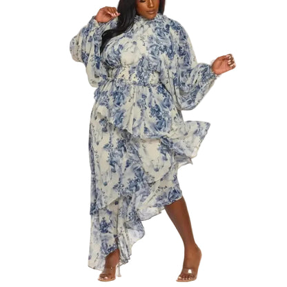 Woman wearing a blue and white floral maxi-dress on a white background