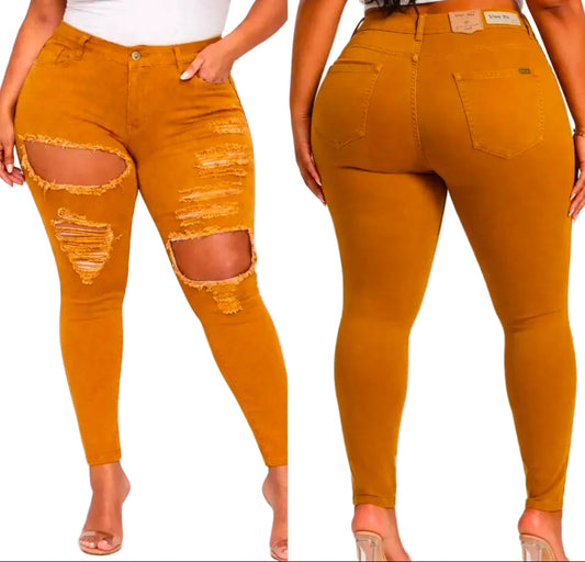Plus-size mustard yellow distressed skinny jeans shown from both front and back views on a model. The jeans feature large ripped details on the thighs and knees.