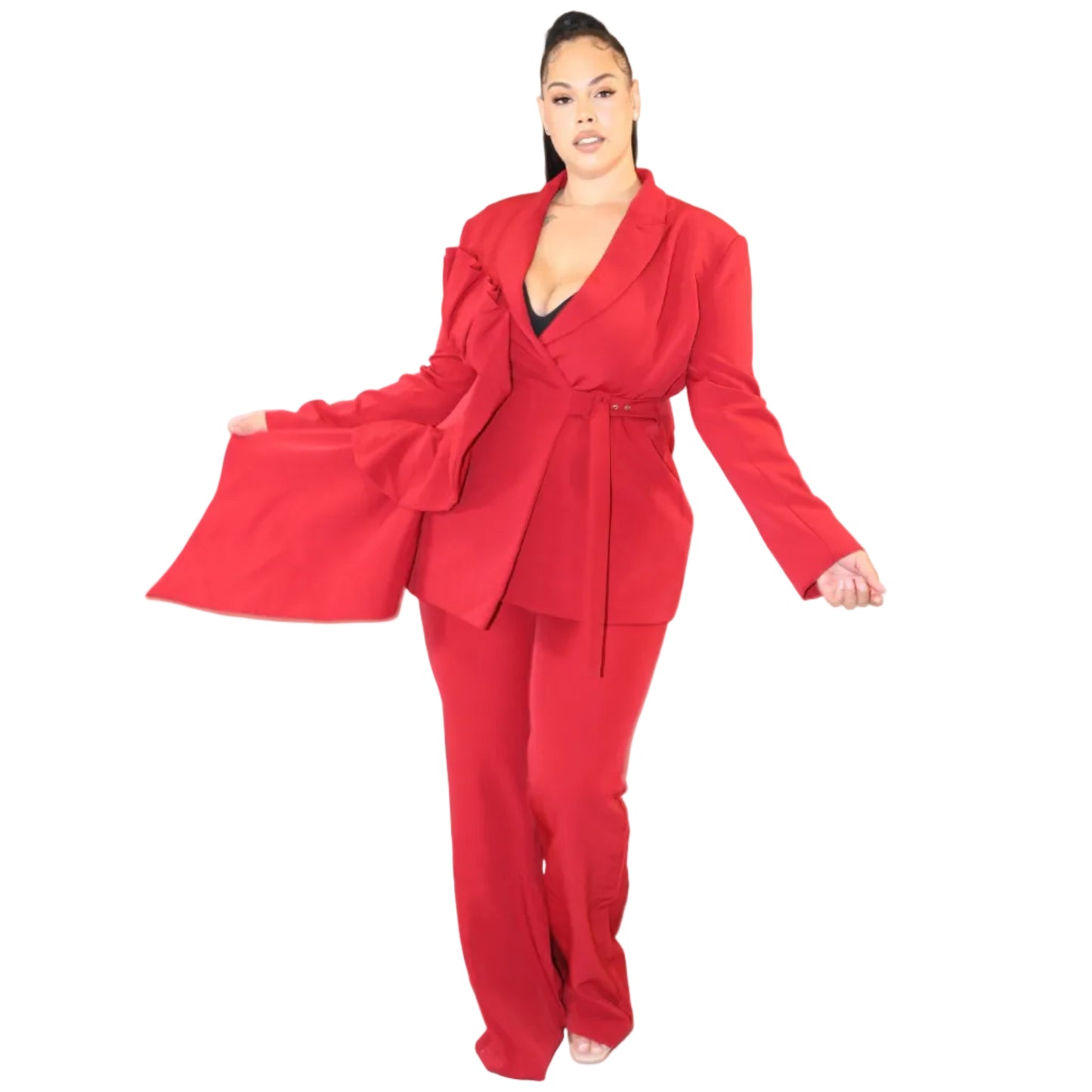 Woman wearing a red suit against a plain background holding out the top's detailing to her right (front)