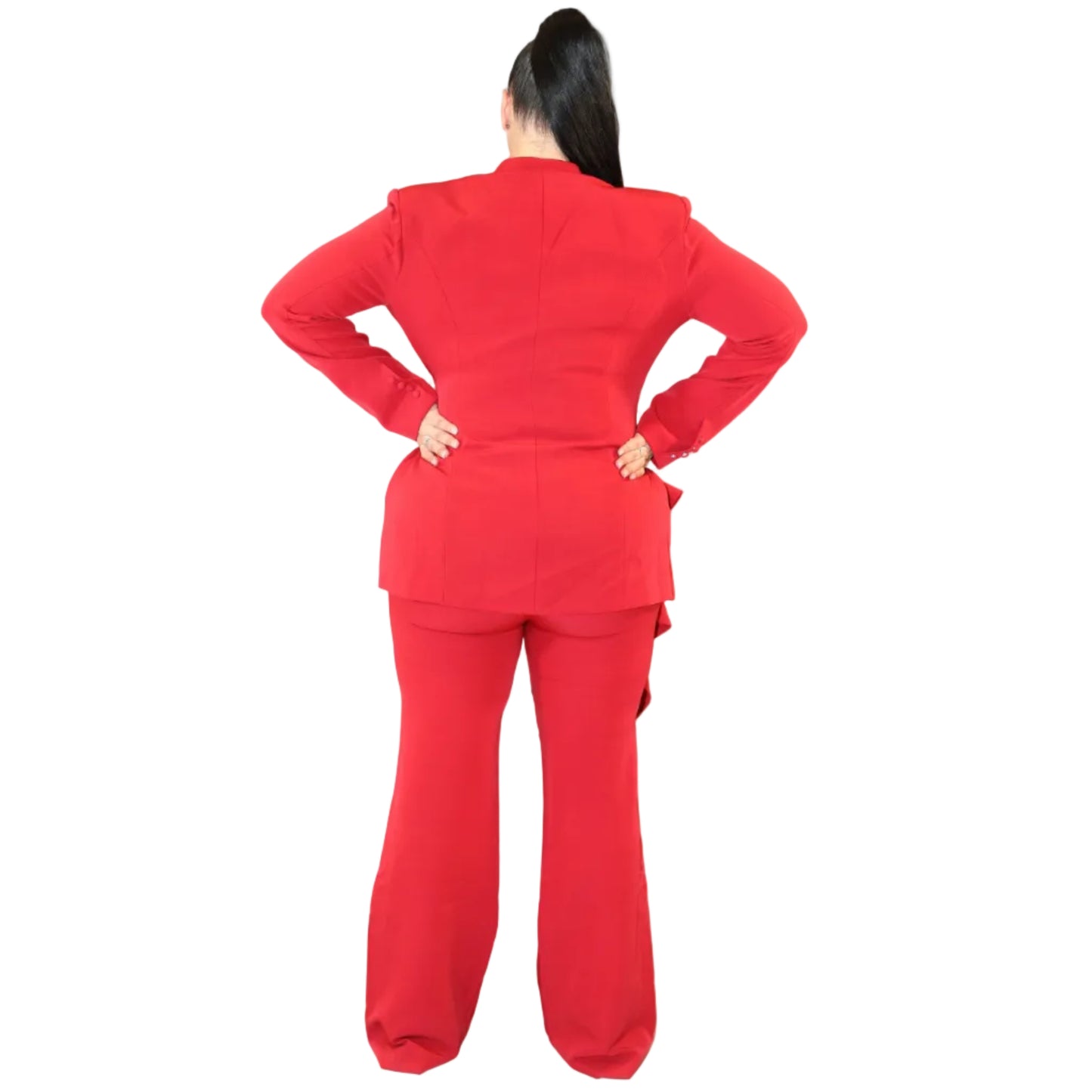 Woman wearing a red suit against a plain background with her hands on her hips (back)