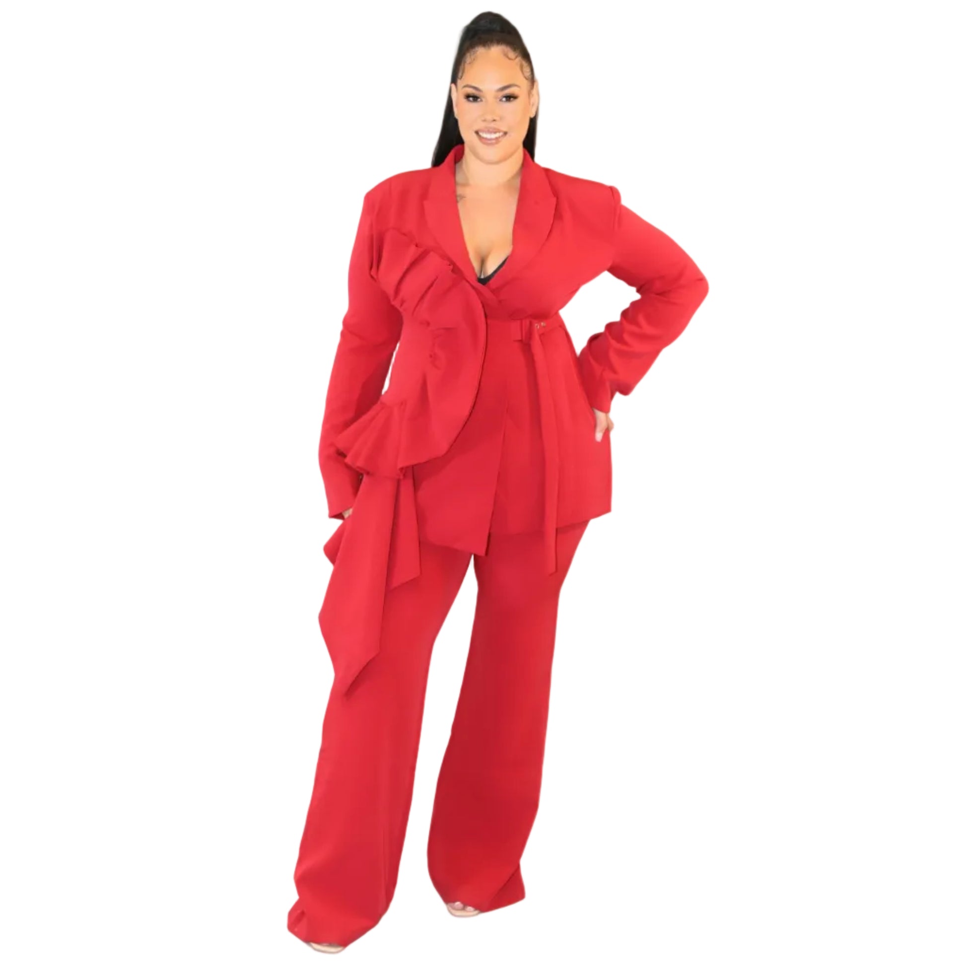 Woman wearing a red suit against a plain background with her hand on her hip (front)