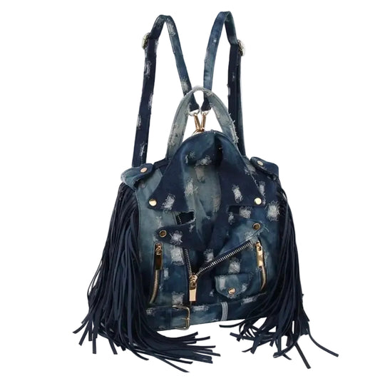 Dark blue denim bag with backpack straps, a handle, fringe, and gold hardware on a white background. (angled)