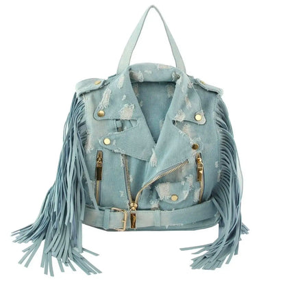 Light blue denim bag with backpack straps, a handle, fringe, and gold hardware on a white background. (front)