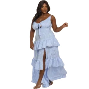 Woman wearing a blue and white striped dress with ruffled layers on a white background