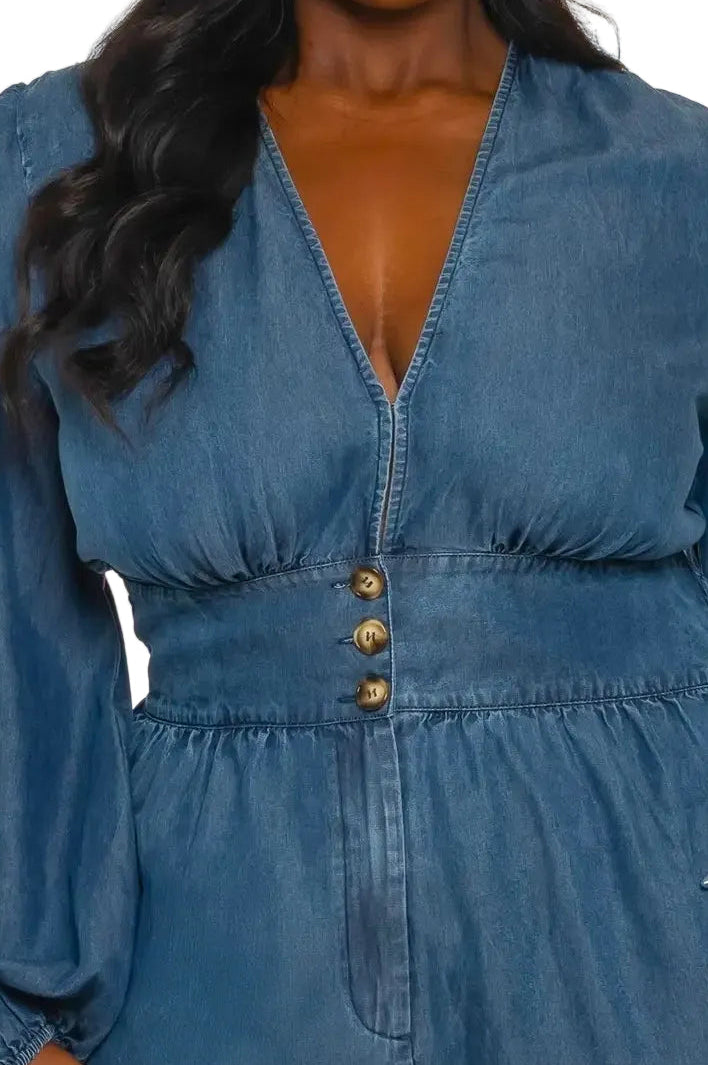 Close up of a woman wearing a blue denim jumpsuit on a white background