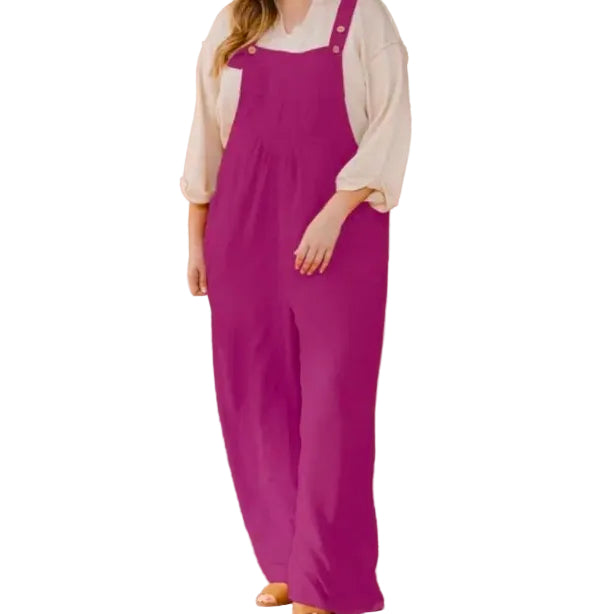 Woman wearing a white shirt and magenta overalls on a white background.