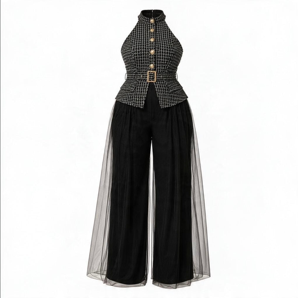 A women's high-neck jumpsuit featuring a black and white micro-check patterned bodice with gold-tone buttons and a matching belt, paired with wide-leg black pants and sheer black tulle side panels, shown on a plain white background.