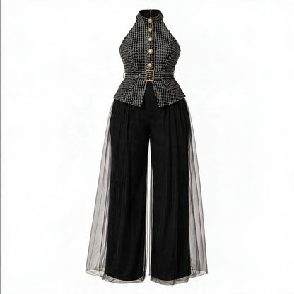 A women's high-neck jumpsuit featuring a black and white micro-check patterned bodice with gold-tone buttons and a matching belt, paired with wide-leg black pants and sheer black tulle side panels, shown on a plain white background.