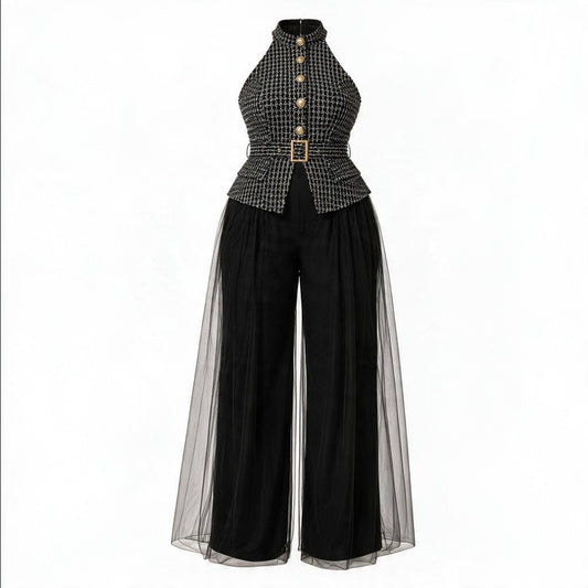 A women's high-neck jumpsuit featuring a black and white micro-check patterned bodice with gold-tone buttons and a matching belt, paired with wide-leg black pants and sheer black tulle side panels, shown on a plain white background.
